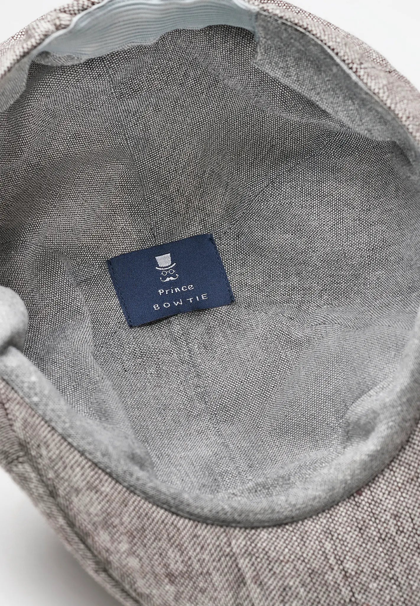 (Beige) Schiebermütze Tweed – Innenseite mit Prince Bowtie Label